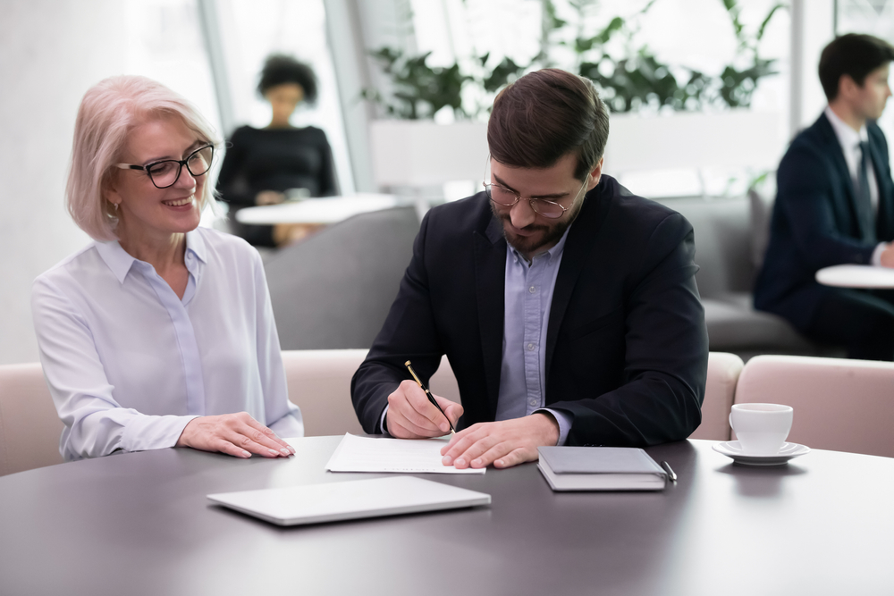 a businessman signing an Employee Ownership Trusts business exit strategy